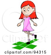 Little Irish School Girl Playing Hopscotch On A Playground