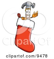 Hammer Mascot Cartoon Character Inside A Red Christmas Stocking by Mascot Junction