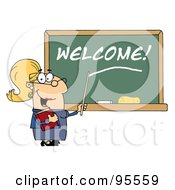 Blond Female School Teacher Pointing To Welcome On A Chalkboard