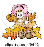 Clipart Picture Of An Ice Cream Cone Mascot Cartoon Character With Autumn Leaves And Acorns In The Fall