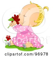Blond Baby Girl Sitting In Grass And Smelling A Red Daisy
