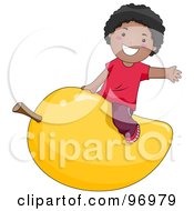 Happy Black Boy Straddling A Giant Mango