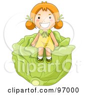 Happy Red Haired Girl Sitting On A Giant Head Of Cabbage
