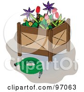 Green Hose Beside A Flower Planter Box