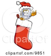 Magnifying Glass Mascot Cartoon Character Wearing A Santa Hat Inside A Red Christmas Stocking by Mascot Junction